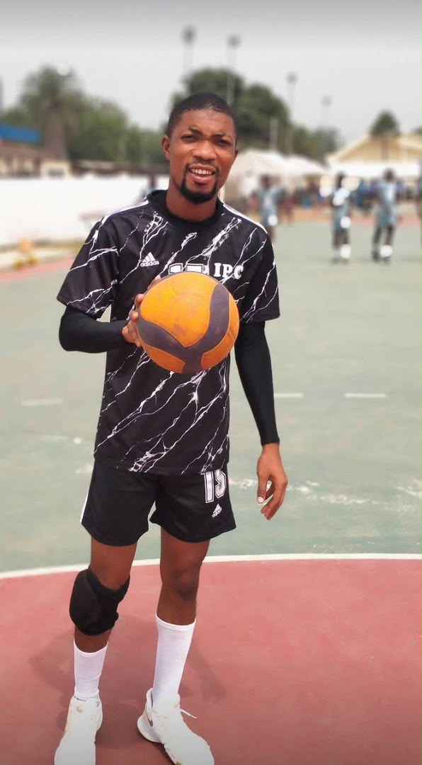 Ebenezer Gabson Gakpo wearing his IPC Volleyball Club jersey and holding a volleyball